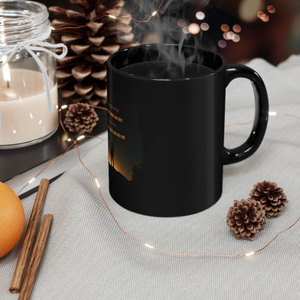 Black ceramic mug with inspirational quote "It is better to be hated for what you are than to be loved for what you are not" printed on it.