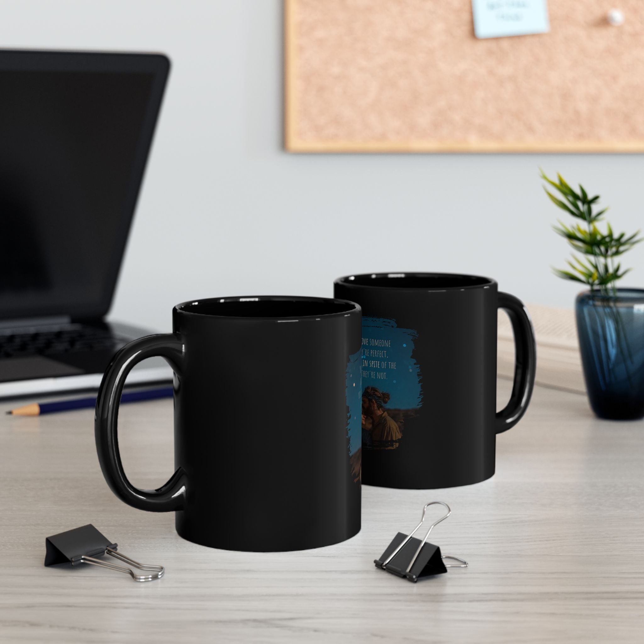 Black ceramic mug with the quote "You don’t love someone because they’re perfect, you love them in spite of that" printed on it.